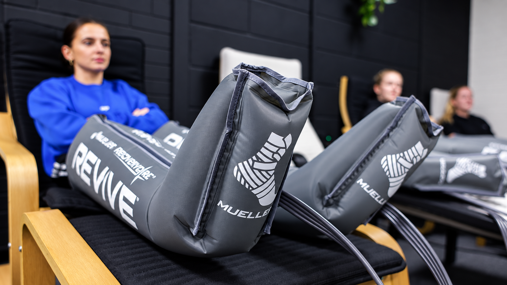 Client using pneumatic compression boots for sports recovery at FOMA Wellness & Recovery Hub, Newtownabbey